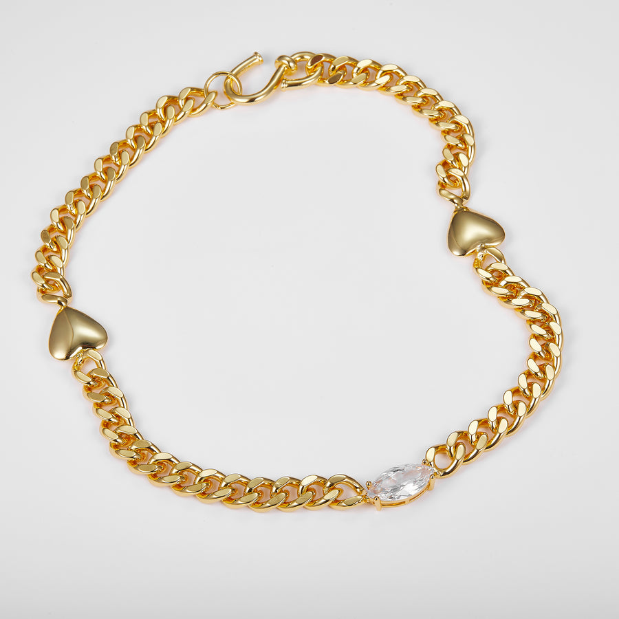 Gold chain necklace with heart-shaped links and white cubic zirconia